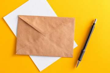 lank white card with kraft brown paper envelope