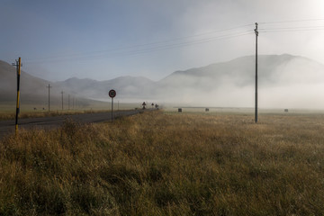 Road to Castelluccio di Norcia (Umbria, Italy) at dawn, with mis © Massimo