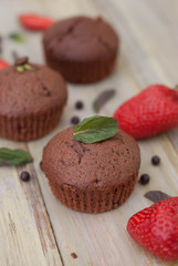 Chocolate Muffins with Strawberry Mint Leaves over rustic Gray Background Breakfast desert