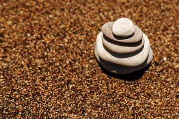 Fototapeta na wymiar Stack of stones on the beach near sea