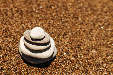 Fototapeta na wymiar Stack of stones on the beach near sea