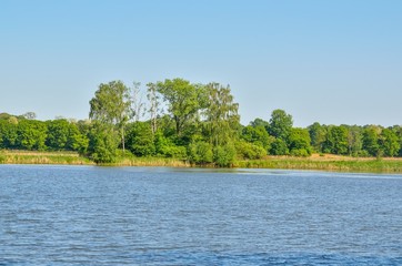 Beautiful rural landscape. Spring day over a beautiful pond.