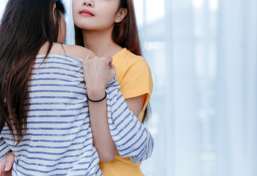 Same sex asian lesbian couple lover embrace and kiss erotic scene in the  bedroom happiness feeling, LGBT sexuality female hug living together at  home. Stock Photo | Adobe Stock
