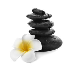 Fototapeta na wymiar Stack of spa stones and flower on white background