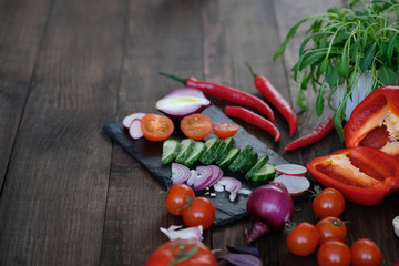 vegetables for salad on an old wooden table.