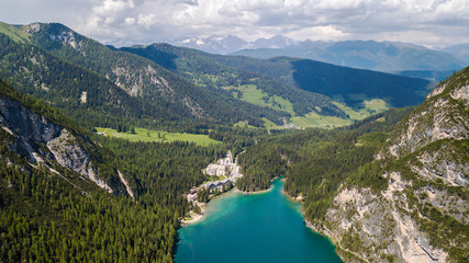 Naklejka na ściany i meble Aerial view of the crystal clear lake Lago Di Braies with house