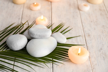 Plakat Beautiful composition with spa stones and candles on wooden table