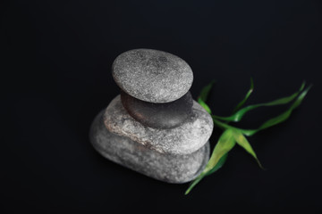 Stack of spa stones on black background