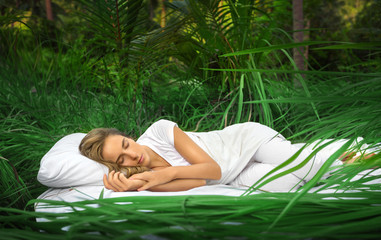 A hidden place. Sleeping woman in deep jungle forest lies on airbed