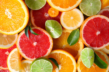 Slices of fresh citrus fruits as background - Powered by Adobe