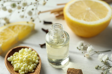 Composition with bottle of citrus essential oil on table