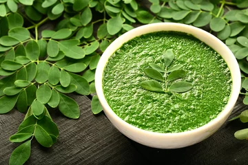 Poster Vegan healthy cream soup made of moringa oleifera leaves. © susansam90