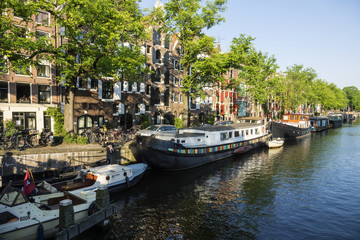 On the banks of the canals of Amsterdam, magnificent boats are transformed into houses