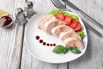Composition with tasty boiled chicken fillet on wooden table