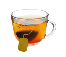 Brewing of hot tea in glass cup on white background