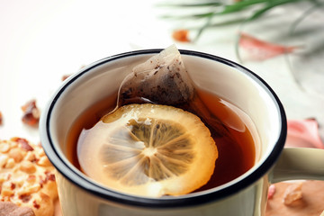 Mug of hot tea with lemon on table, closeup