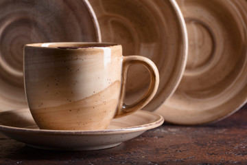 Beige cup of hot drink on a old copper table.
