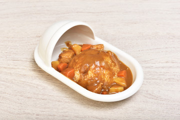 Curry with rice on a plate of shape of toilet
