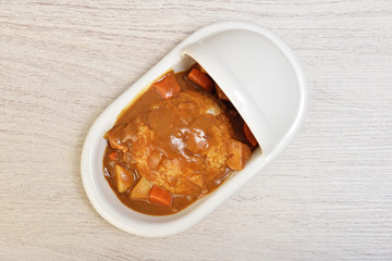 Curry with rice on a plate of shape of toilet