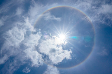 Sun halo in sunny day with clouds