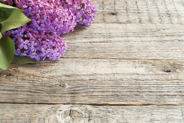 Beautiful lilac flowers on a wooden background copy space.