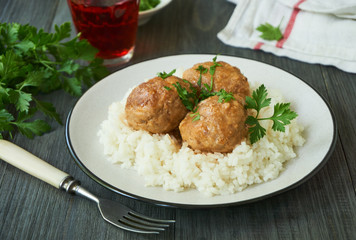 Meatballs in tomato sauce with rice on a plate