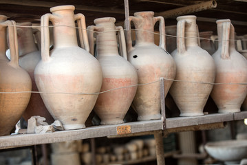 Fototapeta na wymiar Vessels, pots and a variety of artifacts surviving eruption of Vesuvius in Pompeii have been excavated and catalogued .Pompei, Italy