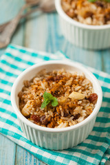 Traditional, mexican baked sweet rice, with almonds, raisins and walnuts.