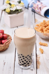 Obraz na płótnie Canvas Milk tea with pearls on wooden table.
