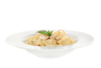 Plate of tasty pasta with chicken fillet on white background
