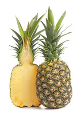 Half of ripe pineapple and whole fruit on white background