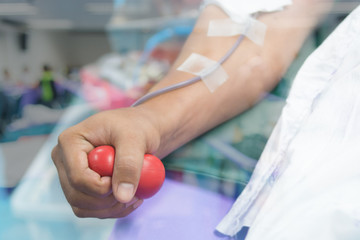 Nurse receiving blood from blood donor in hospital