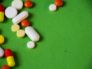 Tablets on a green background.Pills and tablets. Green background. Medical background.