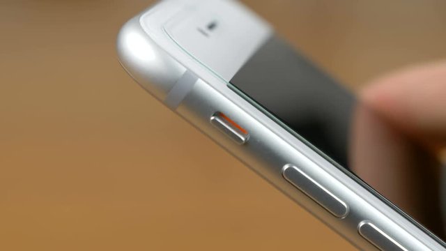 Left hand that puts the smartphone in silent mode