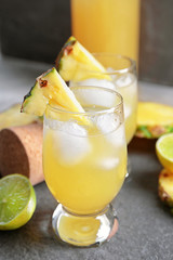 Glasses of tasty fresh pineapple juice on table