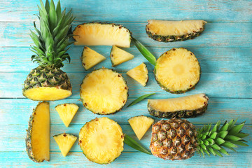 Fototapeta na wymiar Flat lay composition with pineapple slices on wooden background