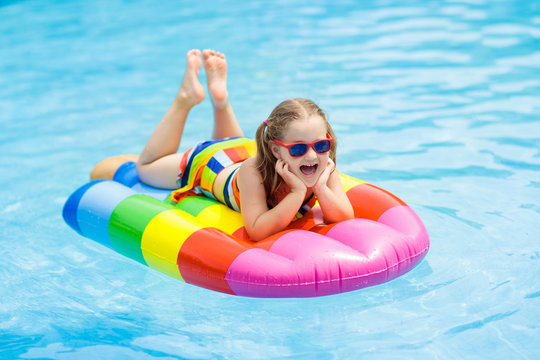 Child on inflatable float in swimming pool.