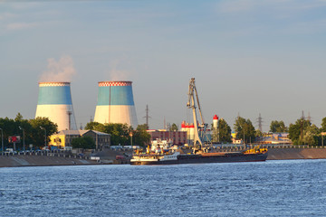 Obraz premium Towers of a thermal power plant, smoke against a blue sky backgr