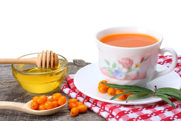 Sea buckthorn juice or tea on old wooden table