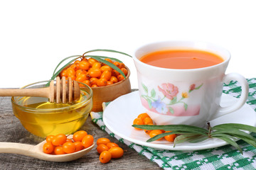 Sea buckthorn juice or tea on old wooden table