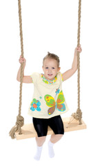 Little girl swinging on a swing