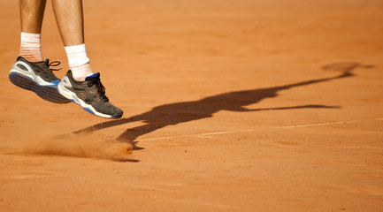 The tennis player puts the ball