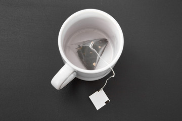 a tea bag in a white cup.