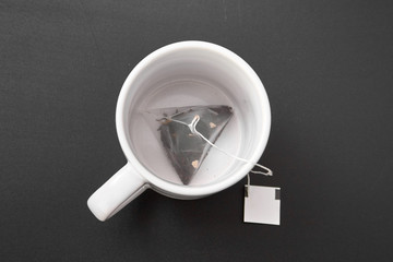 a tea bag in a white cup.