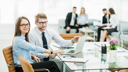 sales Manager and accountant are working on a laptop with financ