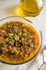 Asian traditional lentil soup with tomatoes and herbs. The view from the top