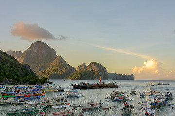 Fishing boats and tourist boats in the harbor of El Nido Palawan, Philippines