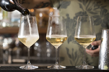 three wine glasses on the bar counter