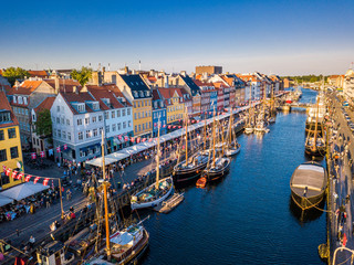 Amazing historical city center. Nyhavn New Harbour canal and entertainment district in Copenhagen, Denmark. The canal harbours many historical wooden ships. Aerial view from the top. - obrazy, fototapety, plakaty