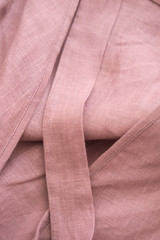 Blush pink soft linen fabric texture. Delicate sensual folds. Fashion designer textile concept